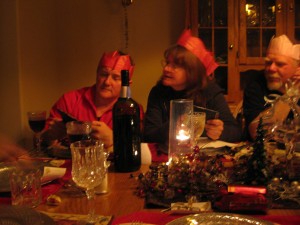 Uncle Johnny, Mum, and Uncle Peter celebrate the Ecksmas tradition of paper crowns and bad jokes.